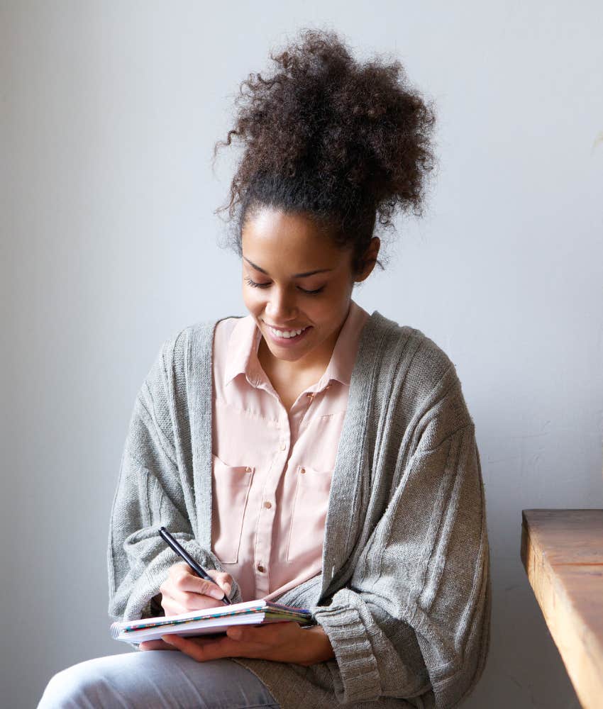 woman writing in a notebook