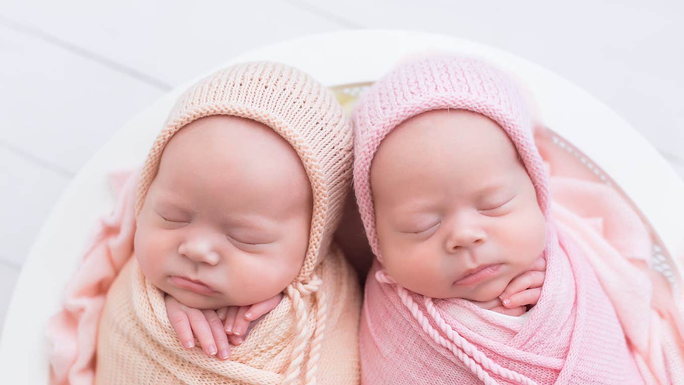 two newborn baby girls swaddled next to each other