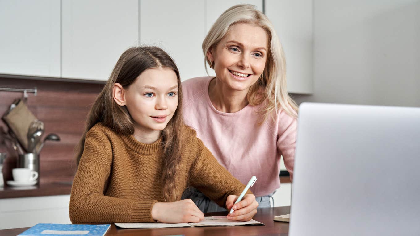 Mom working on homework with young daughter. 