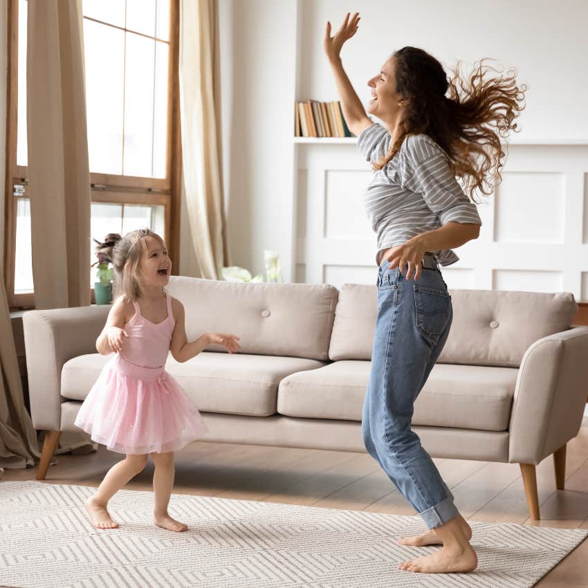 woman and child dancing in a living room