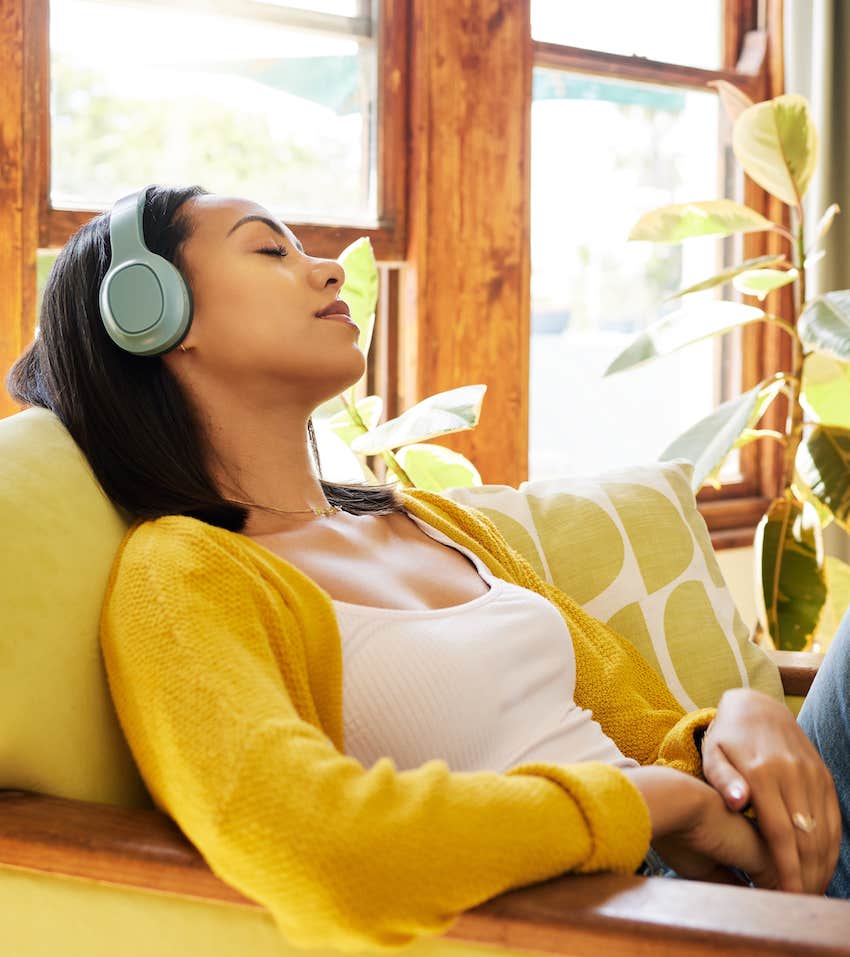 She is relaxing with headphones on to find anxiety relief