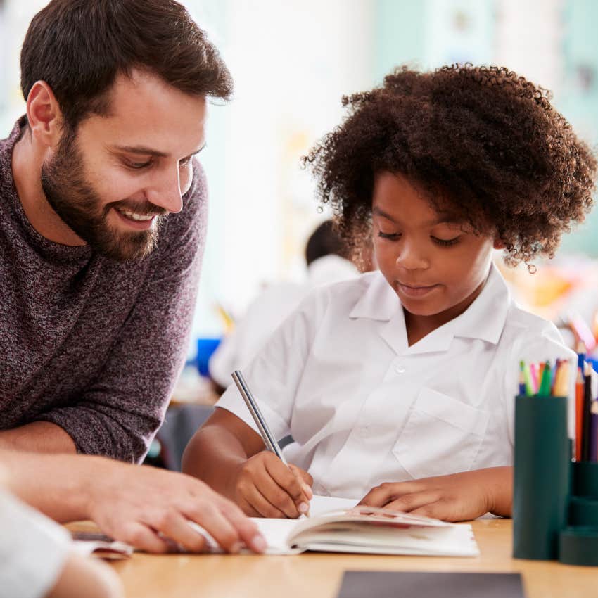 Young dyslexic student working with a teacher. 