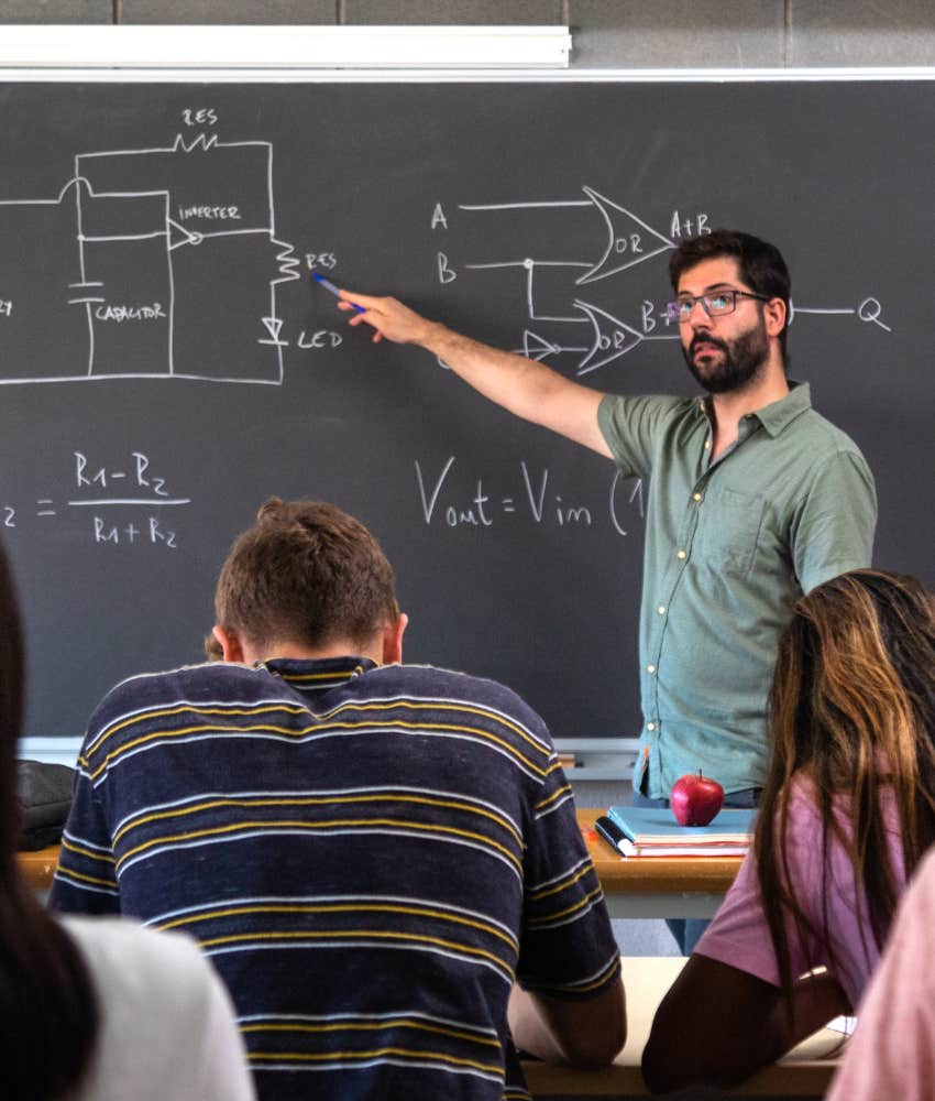 High school teacher at the front of the classroom.