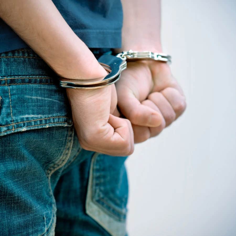 teenager in hand cuffs