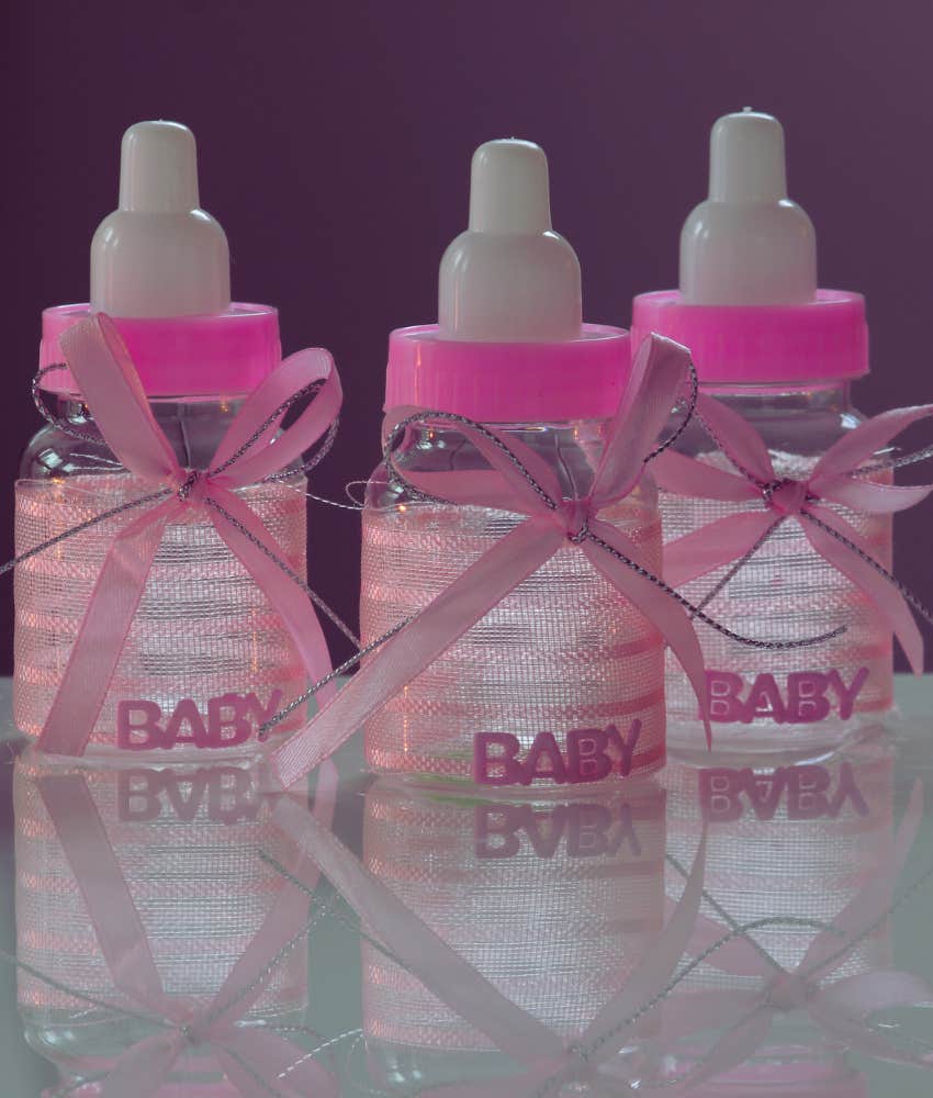three pink baby bottles