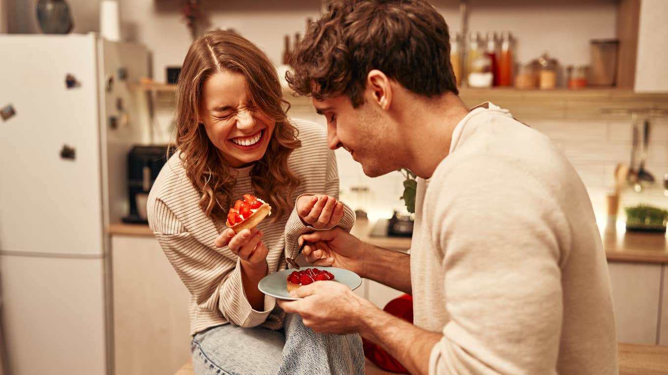 couple laughing while eating together