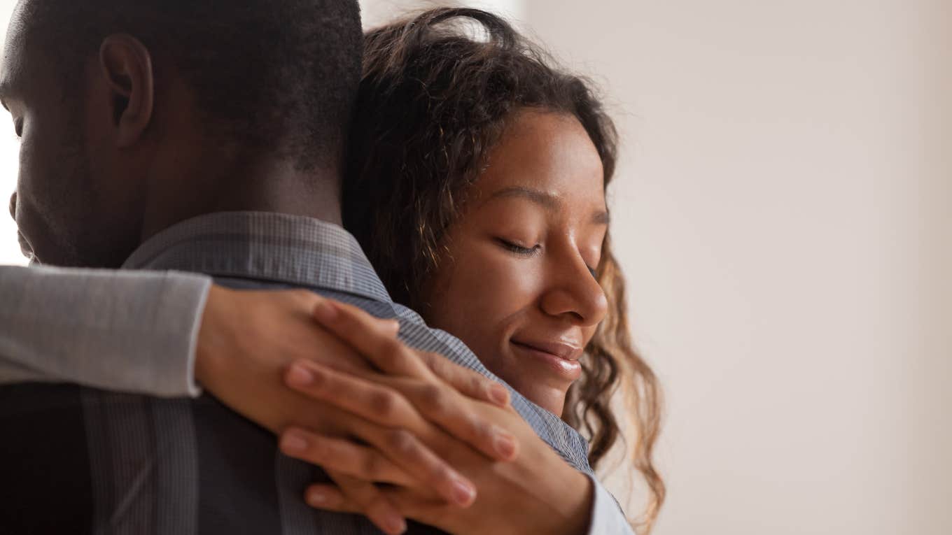 Close up young black wife embracing husband