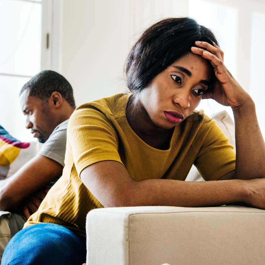 Upset married woman sitting on the couch. 