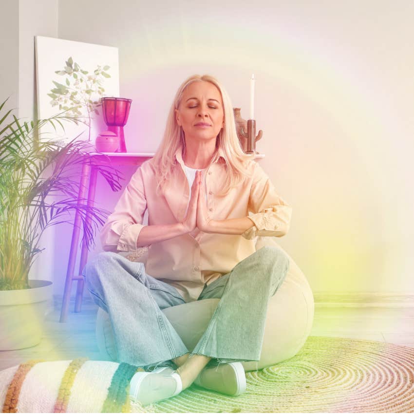 woman meditates and channels colorful aura