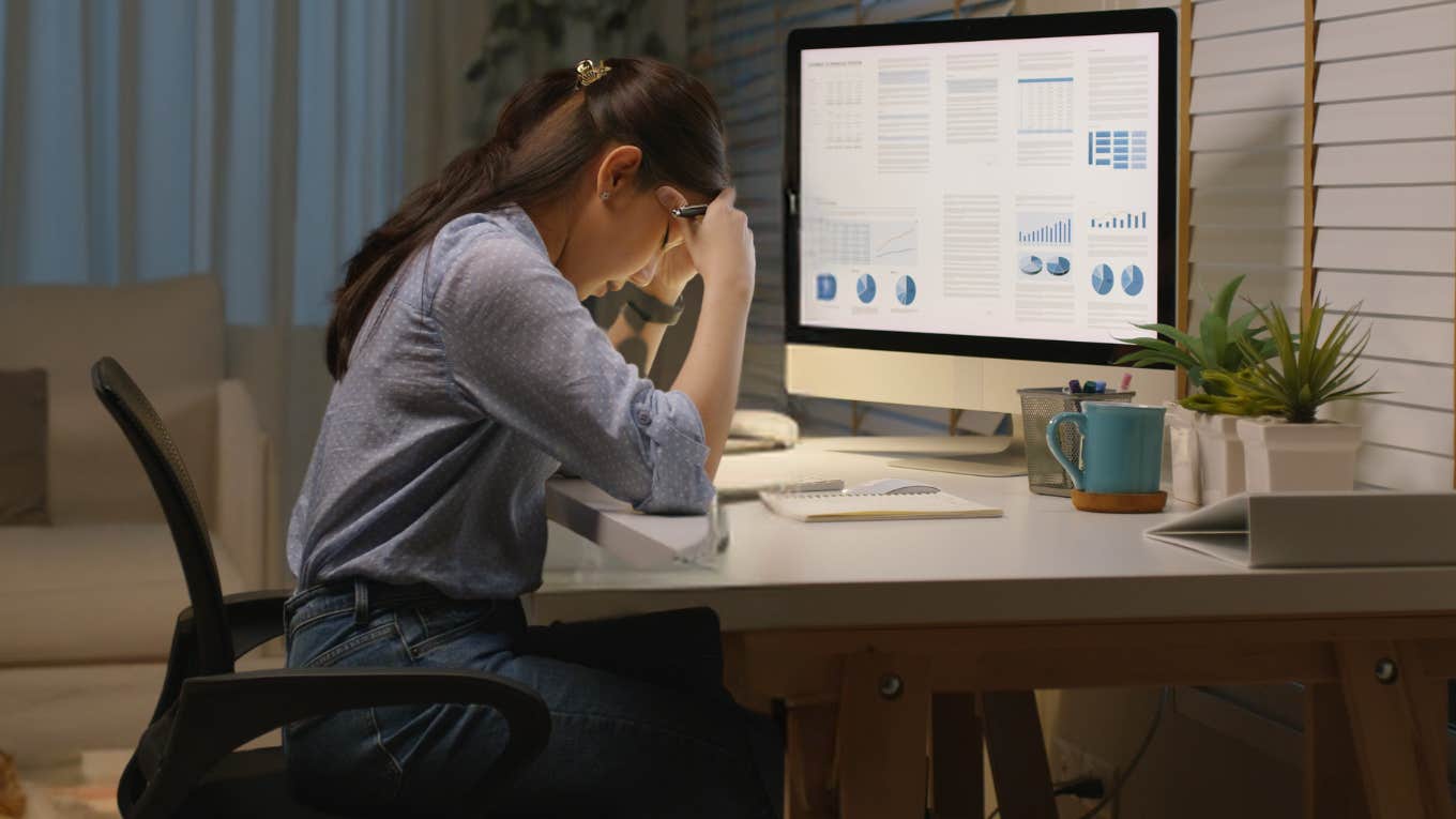 Corporate employee frustrated while working on laptop. 