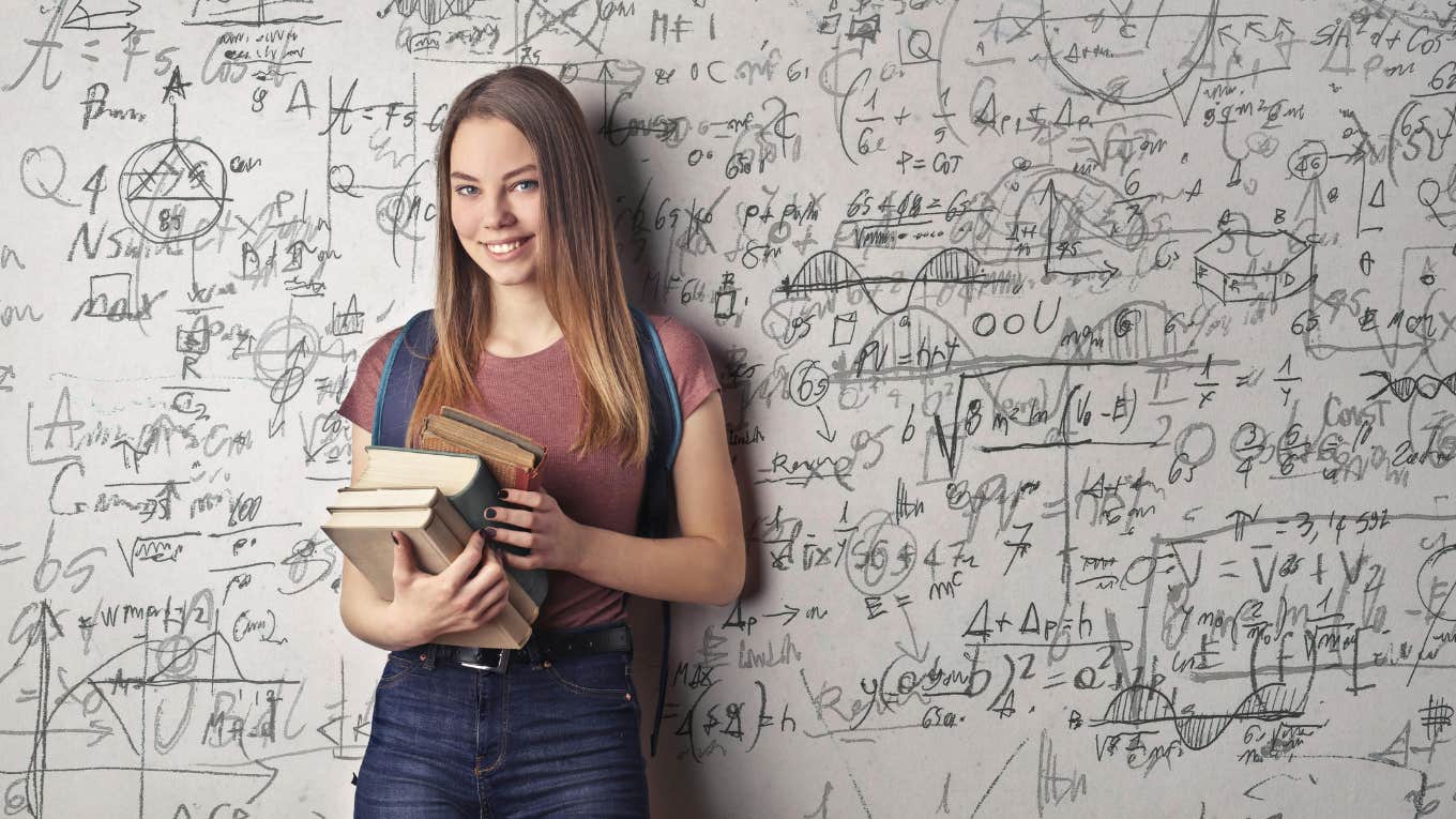 female college student standing at white board