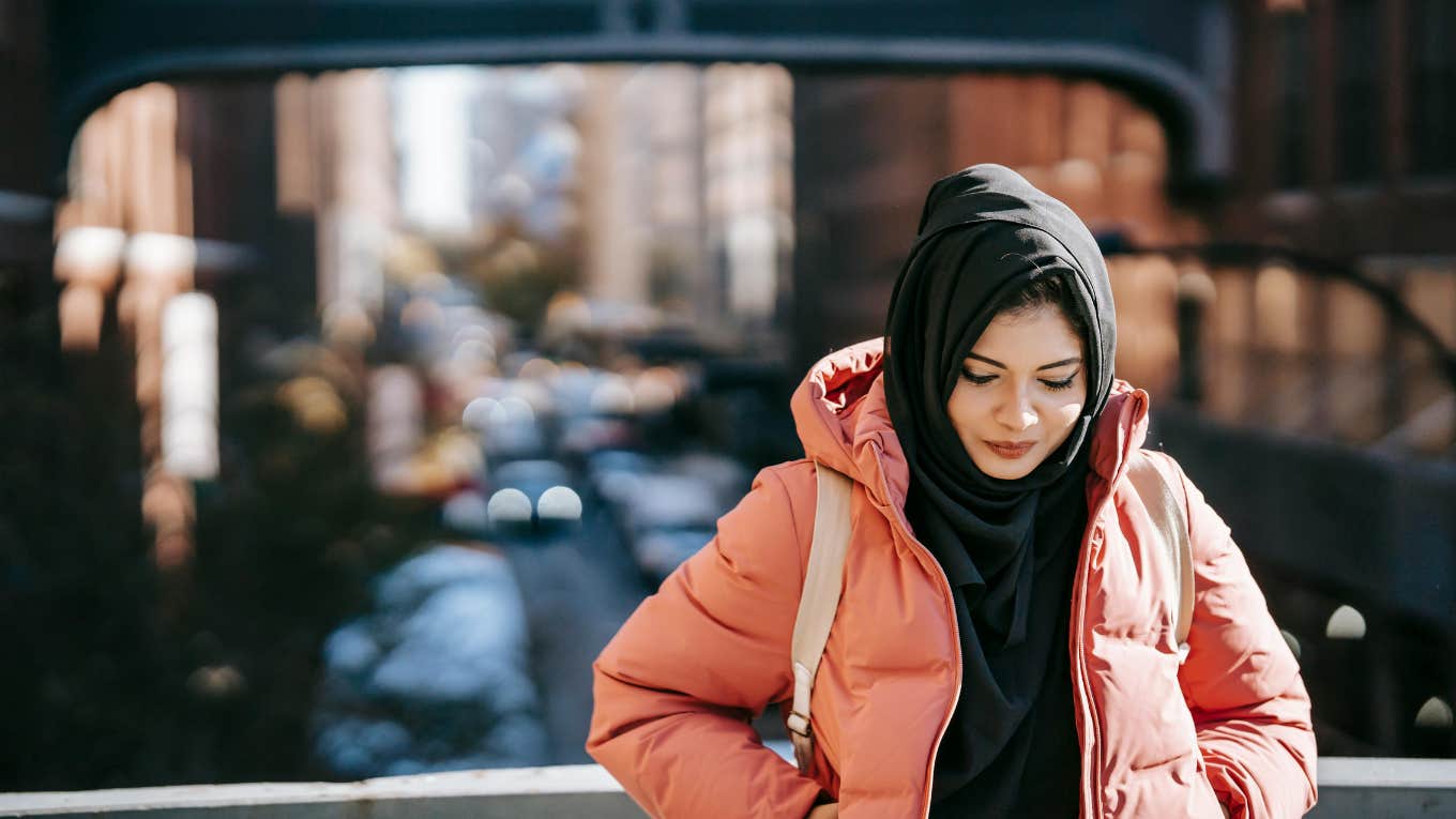 woman standing on a bridge 