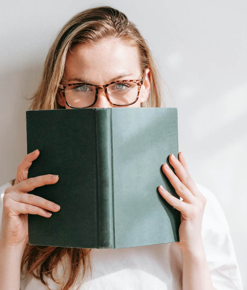 woman holding a book up