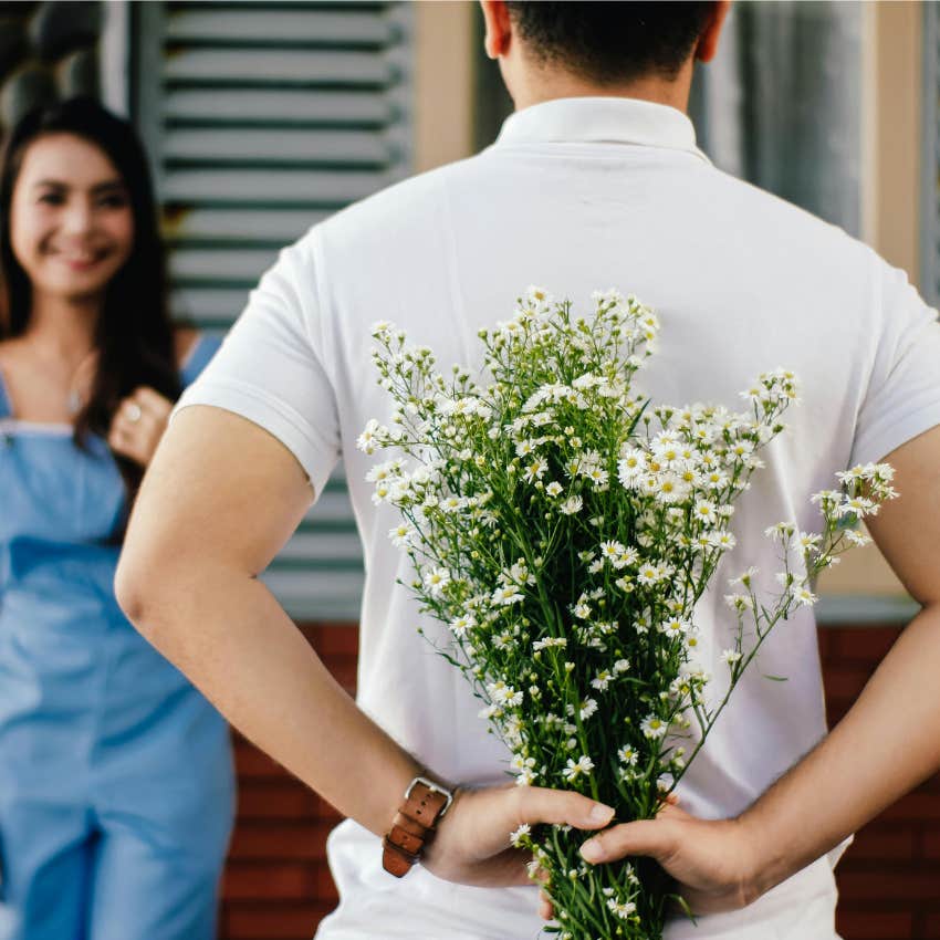 man giving flowers to a woman 