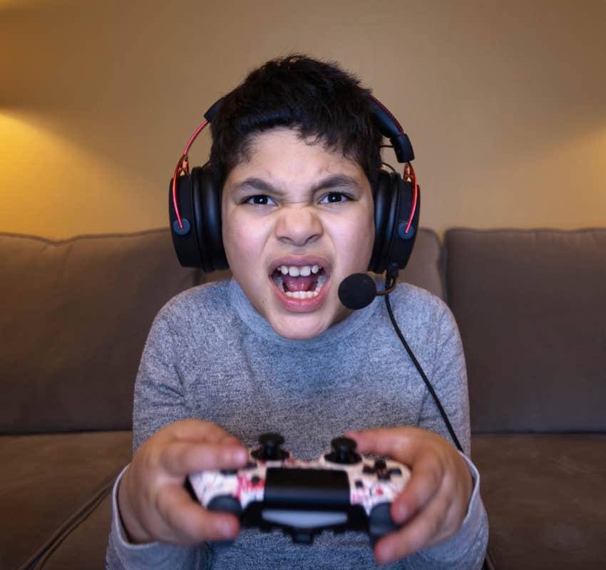 boy gets frustrated and aggressive while playing video games