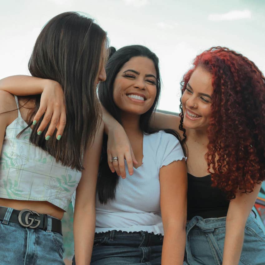 three female friends smiling 