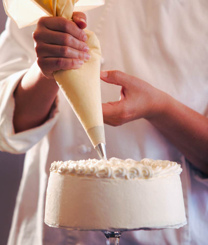 baker decorating a cake