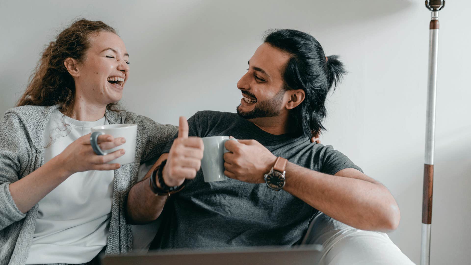 likable man and woman drinking coffee