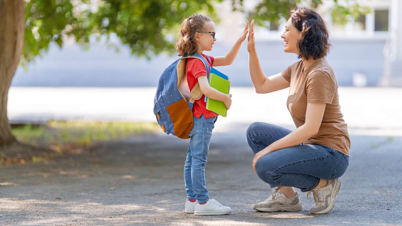 Mom high-fiving young daughter