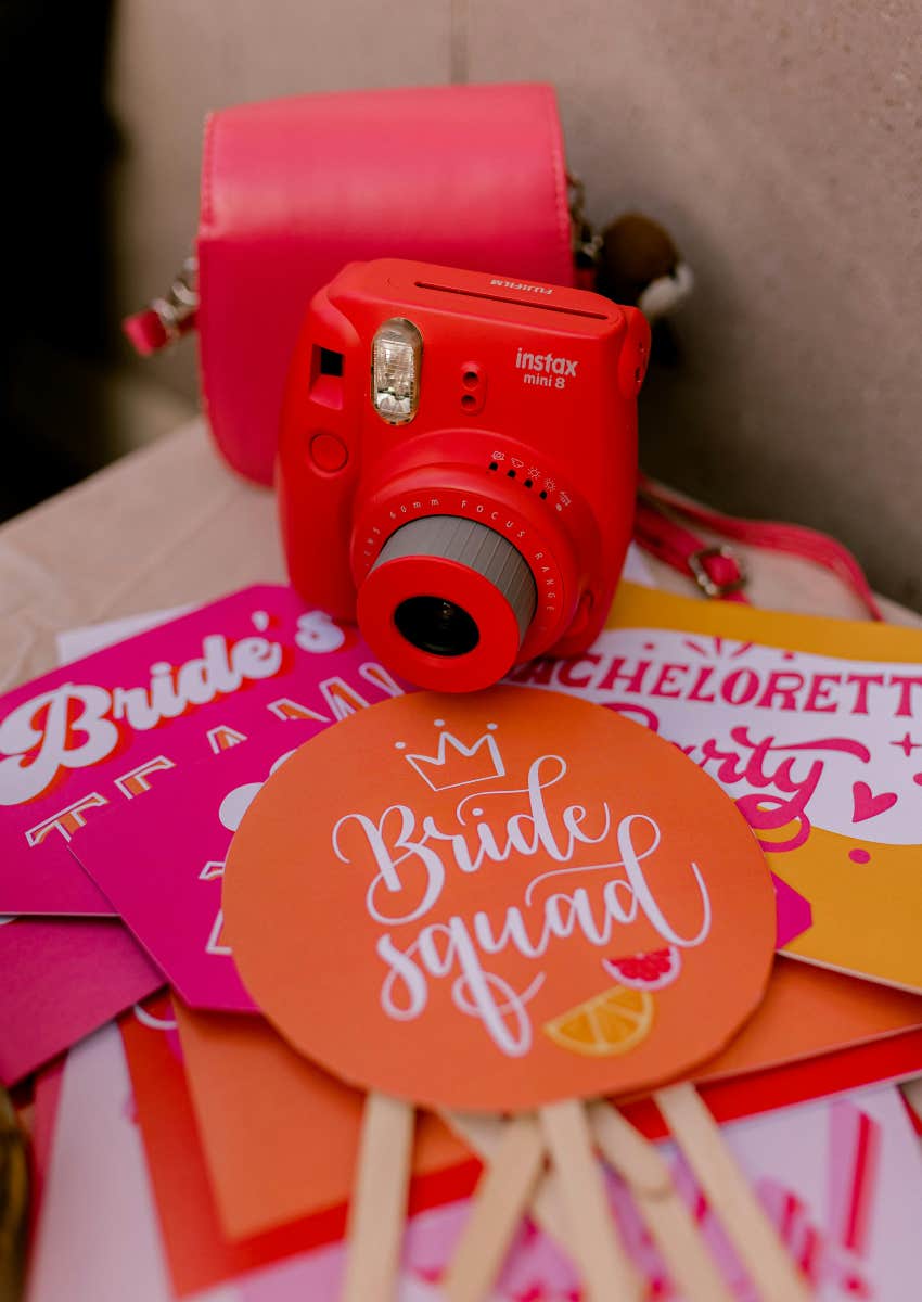 camera and signs used as decorations for bridal shower