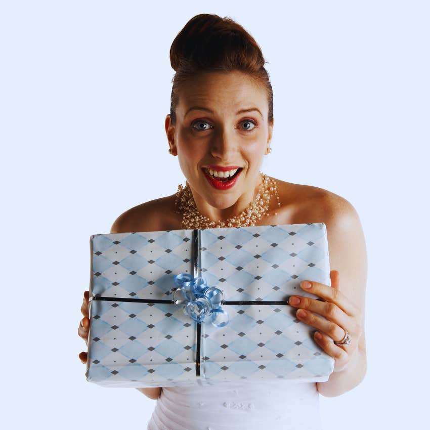 Bride smiling holding wedding present