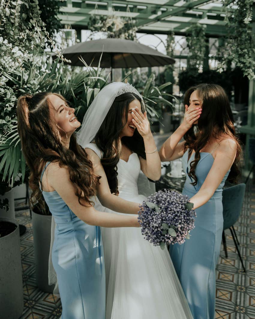 bride laughing with bridesmaids