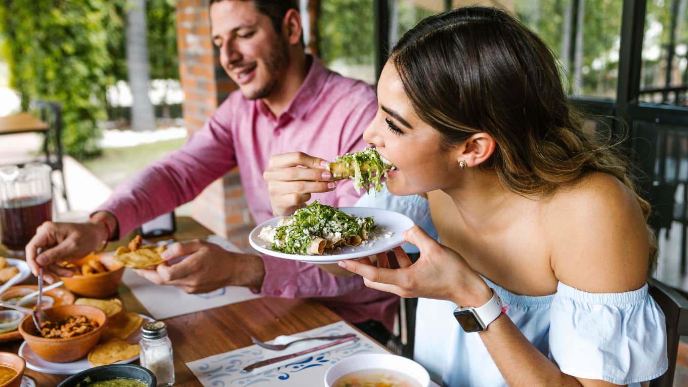 Customers eating a chef's food in a restaurant. 