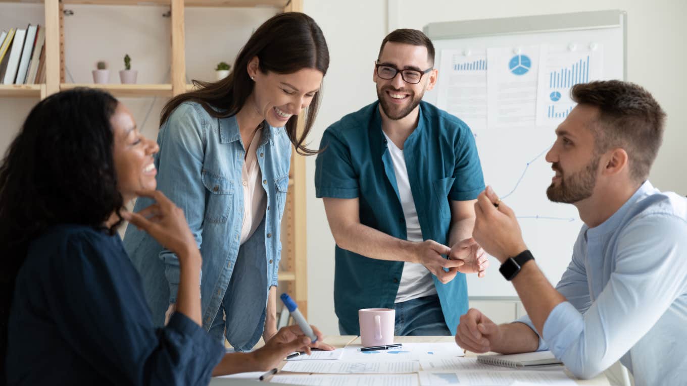 diverse colleagues gather in boardroom brainstorm discuss financial statistics together