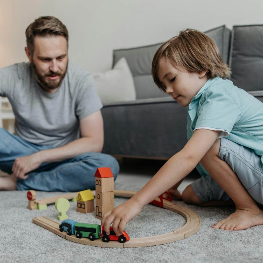 dad and son playing with train set