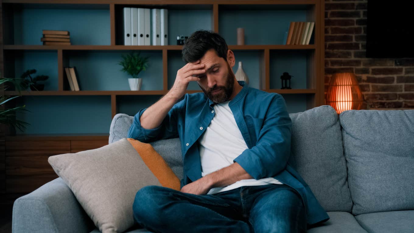 tired father sitting on couch at home