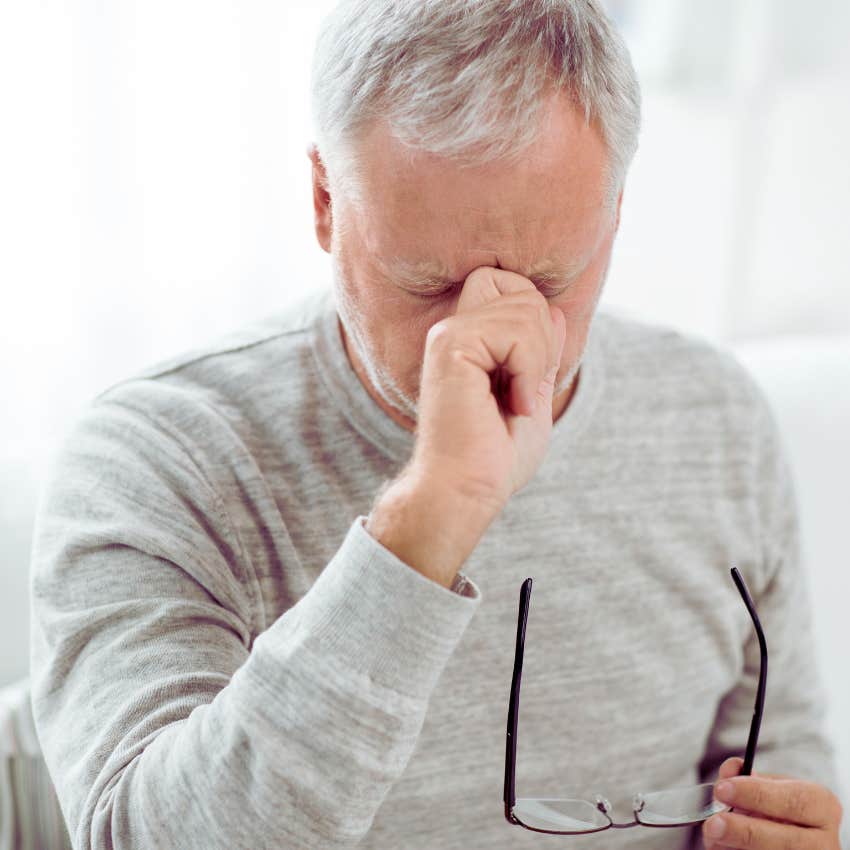 worried man with hand to his forehead