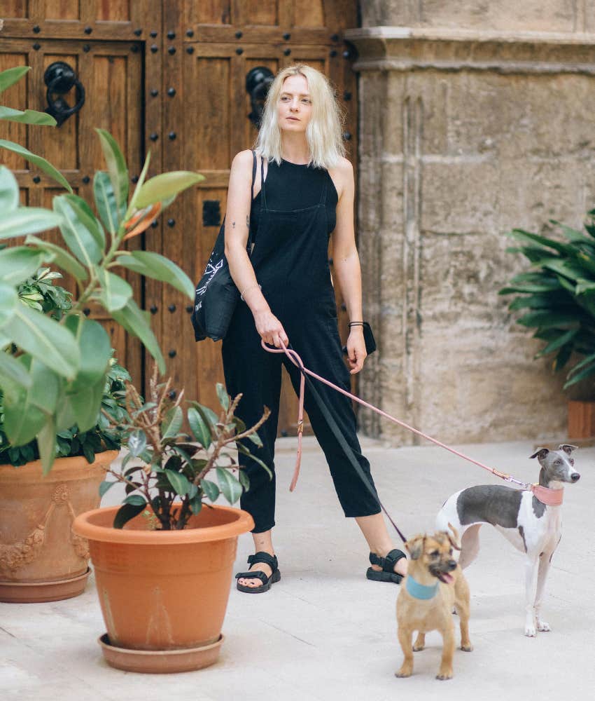 woman walking two dogs