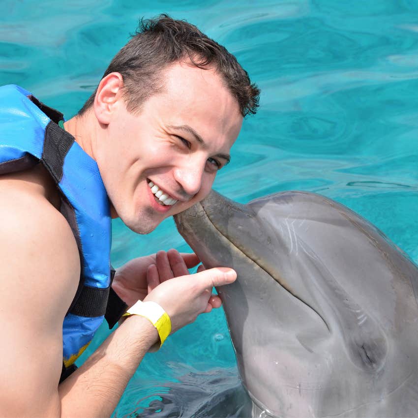 Man in the water with a dolphin. 