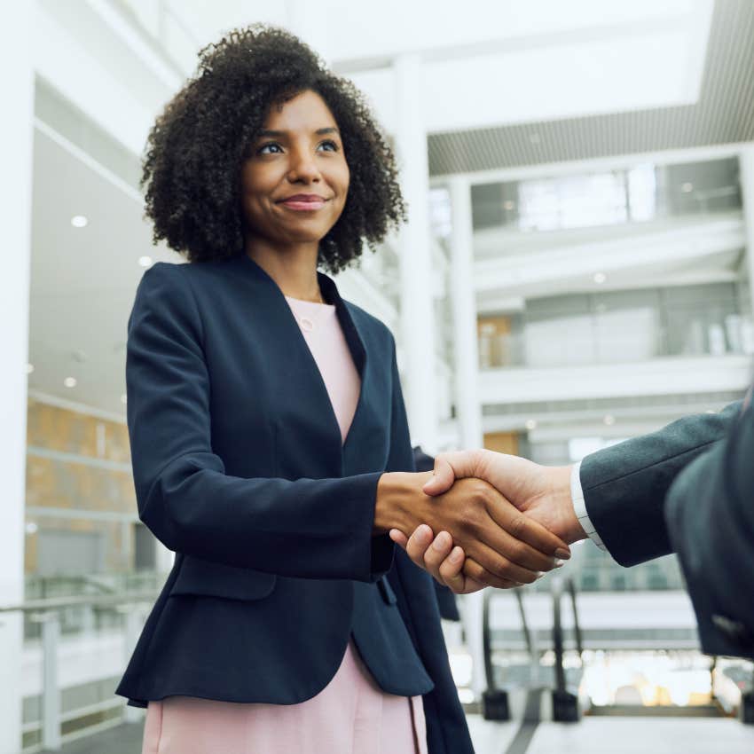 female employee shaking hands during negotiation