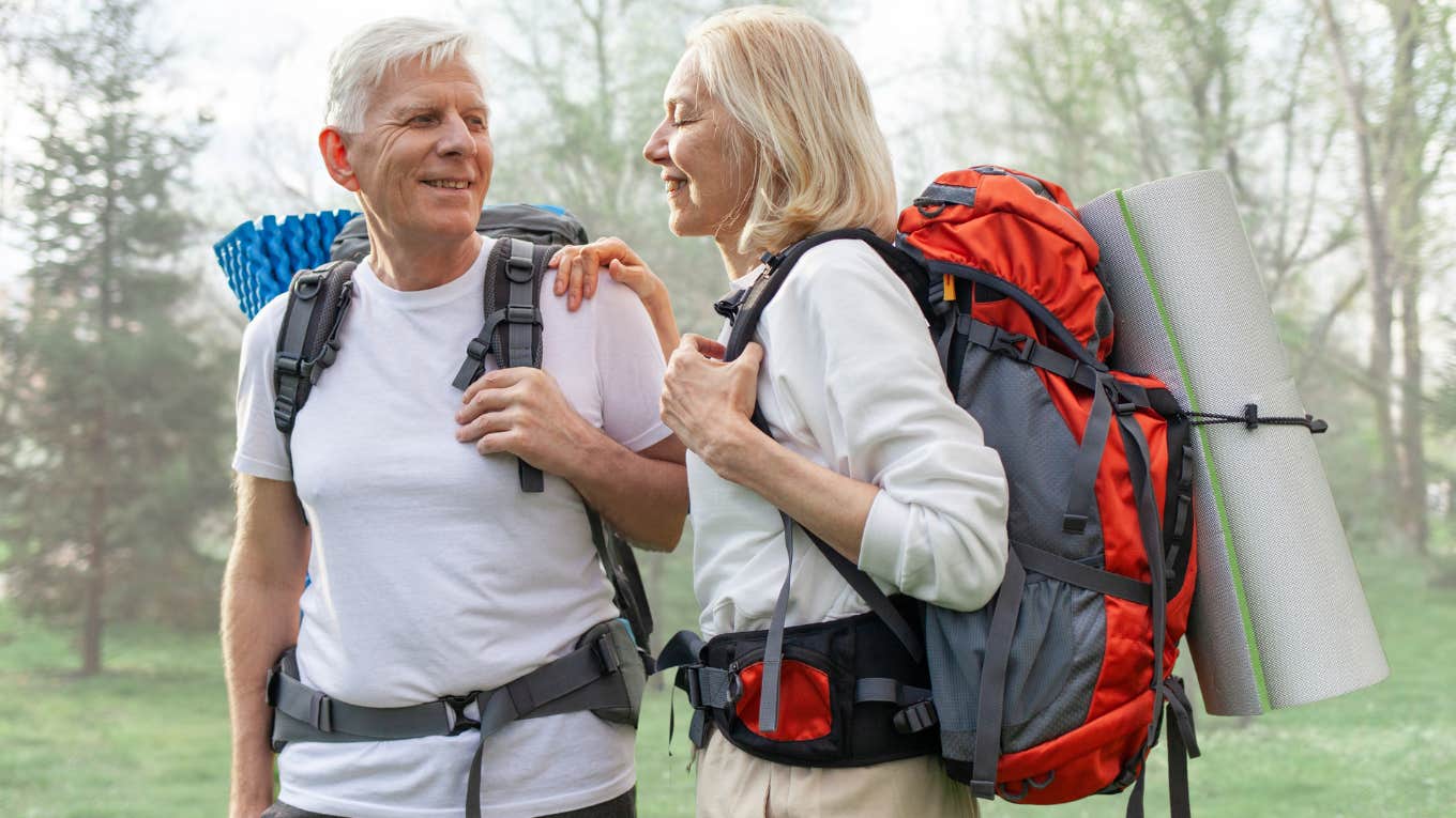 Older couple working out together on a hike. 