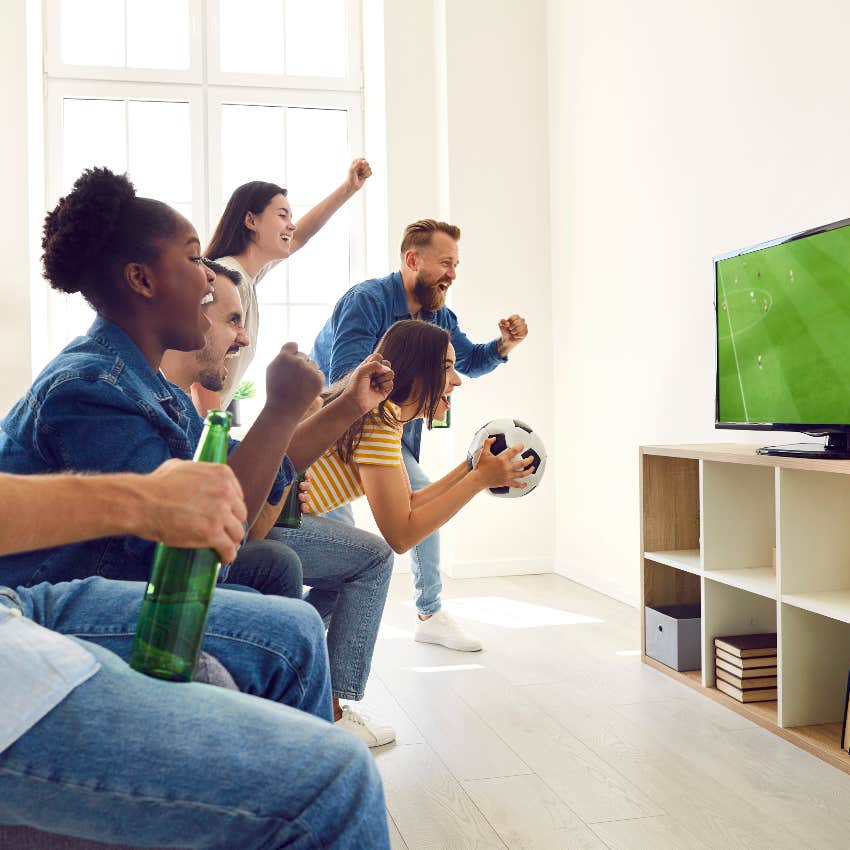 Group of friends watching sports and yelling at the TV