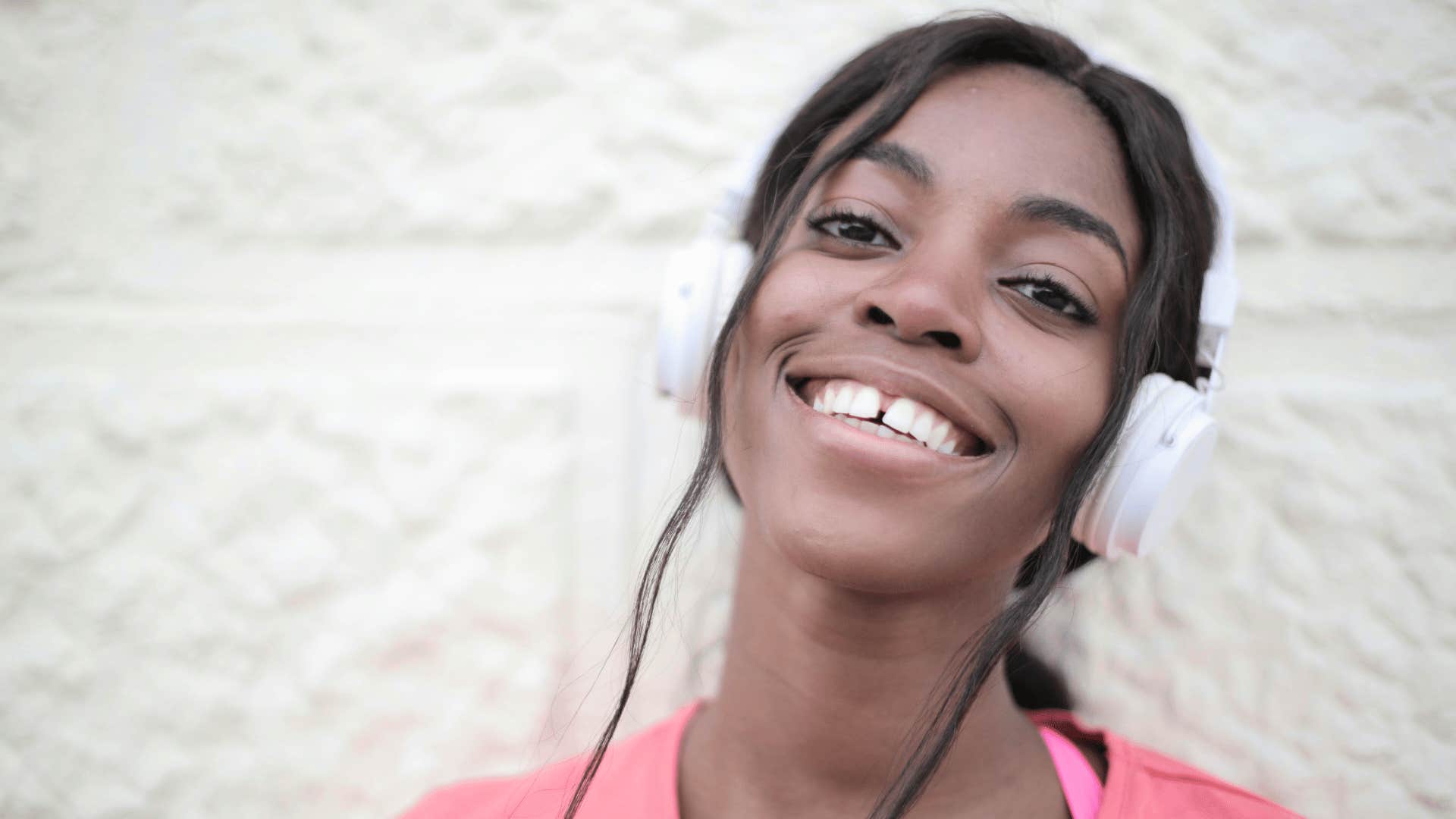 smiling woman with headphones on
