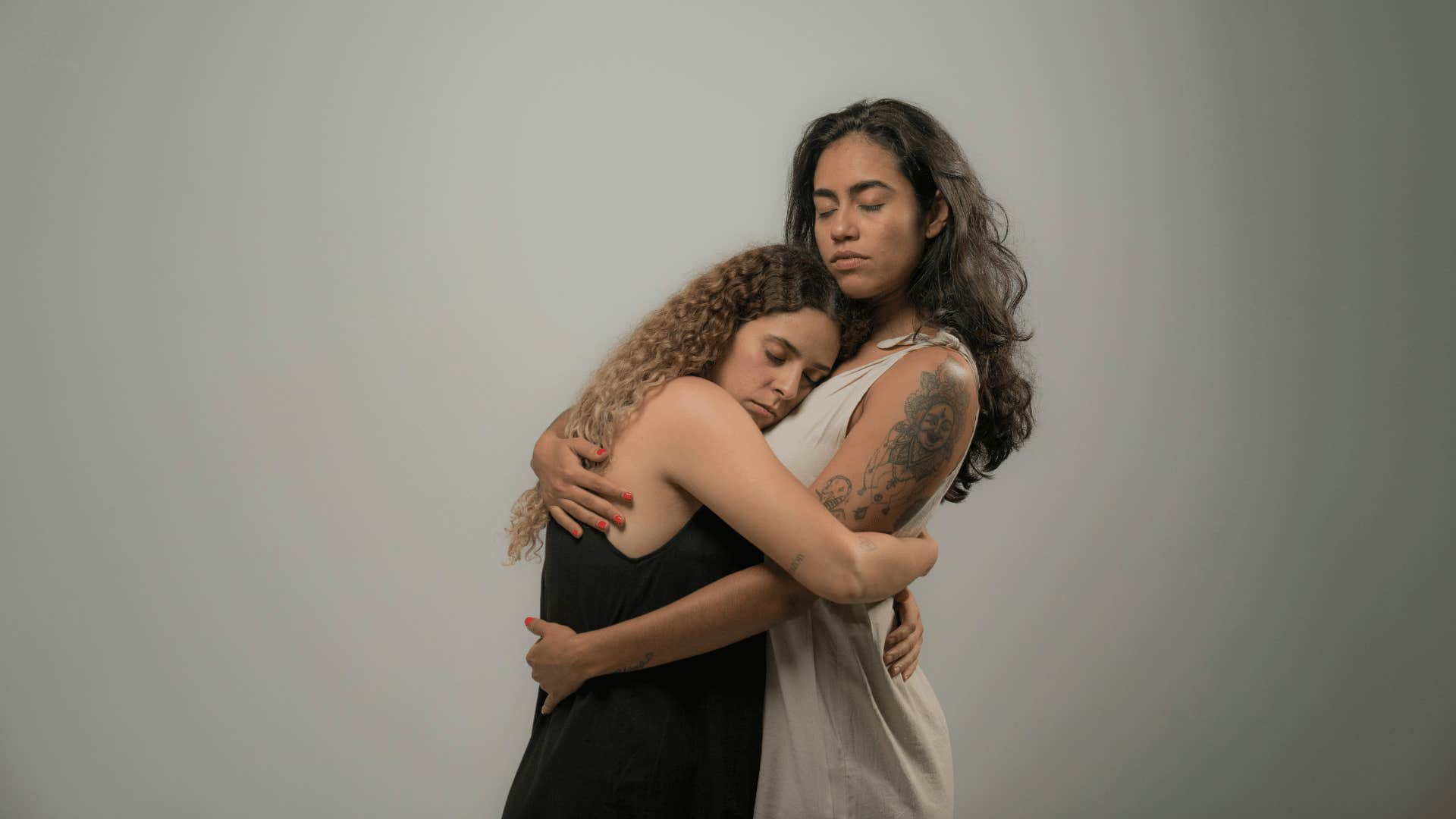 woman comforting another woman