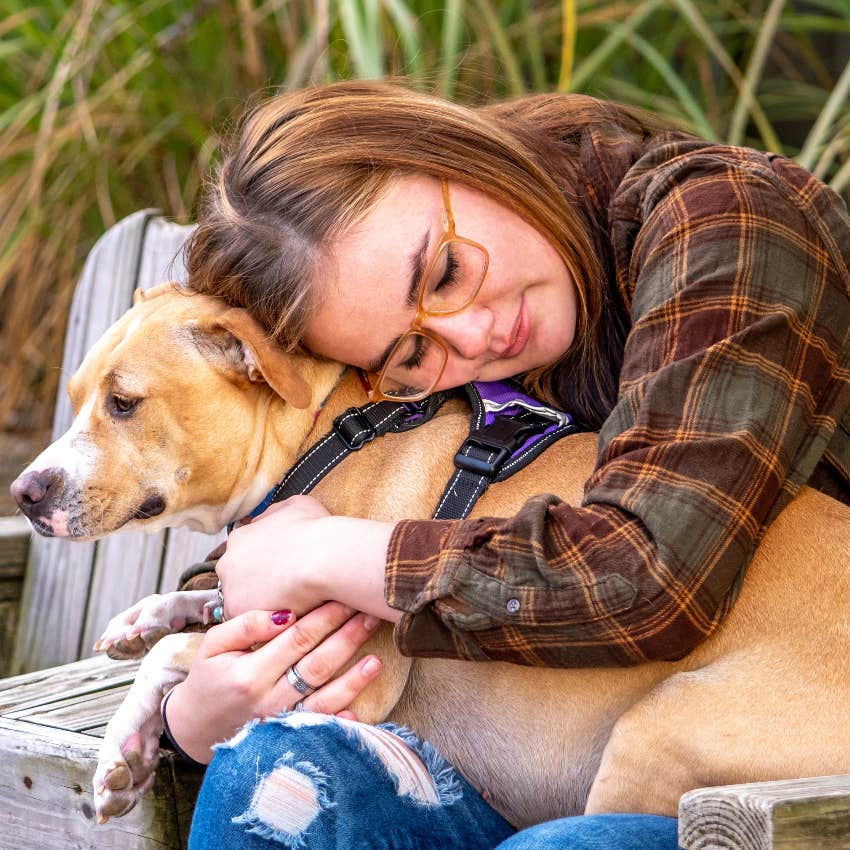 woman hugging service dog