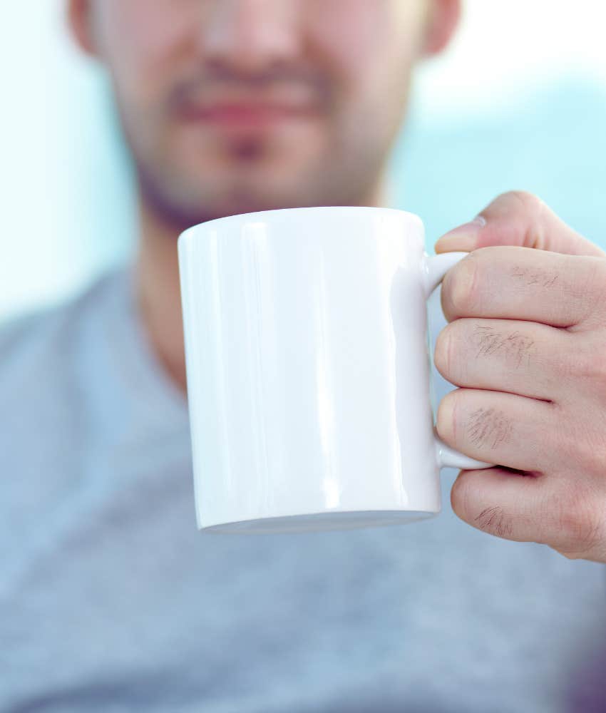 man holding a coffee mug