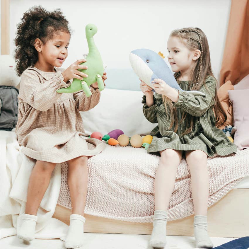 two girls playing with toys