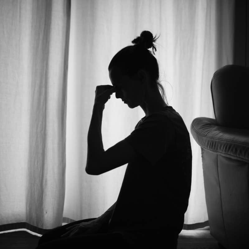 Silhouette of a tired and stressed woman indoors