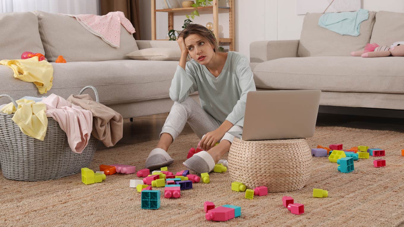 mom picking up toys in living room