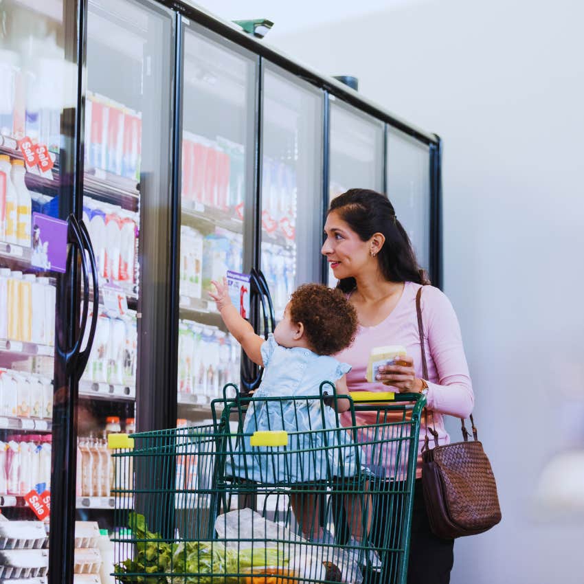 mom shopping at grocery store with infant in carriage