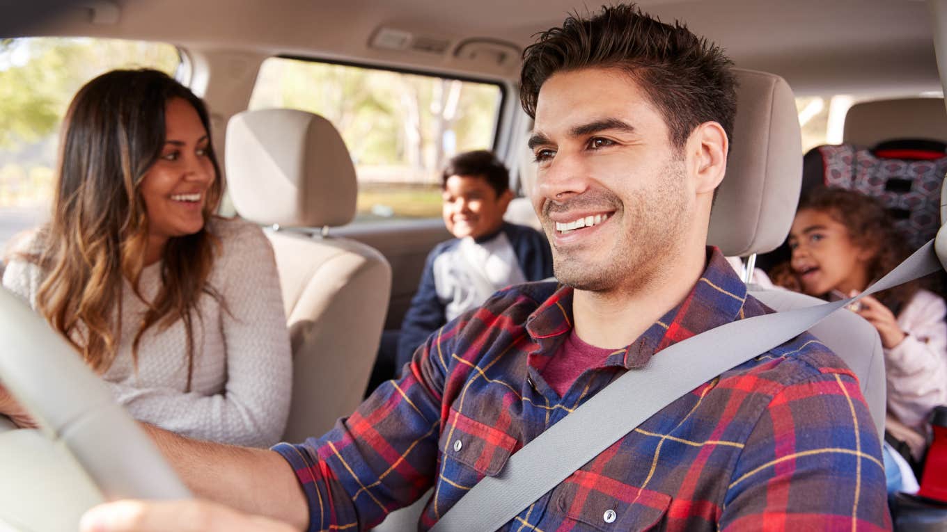 mom turning around in car to look at kids while dad drives