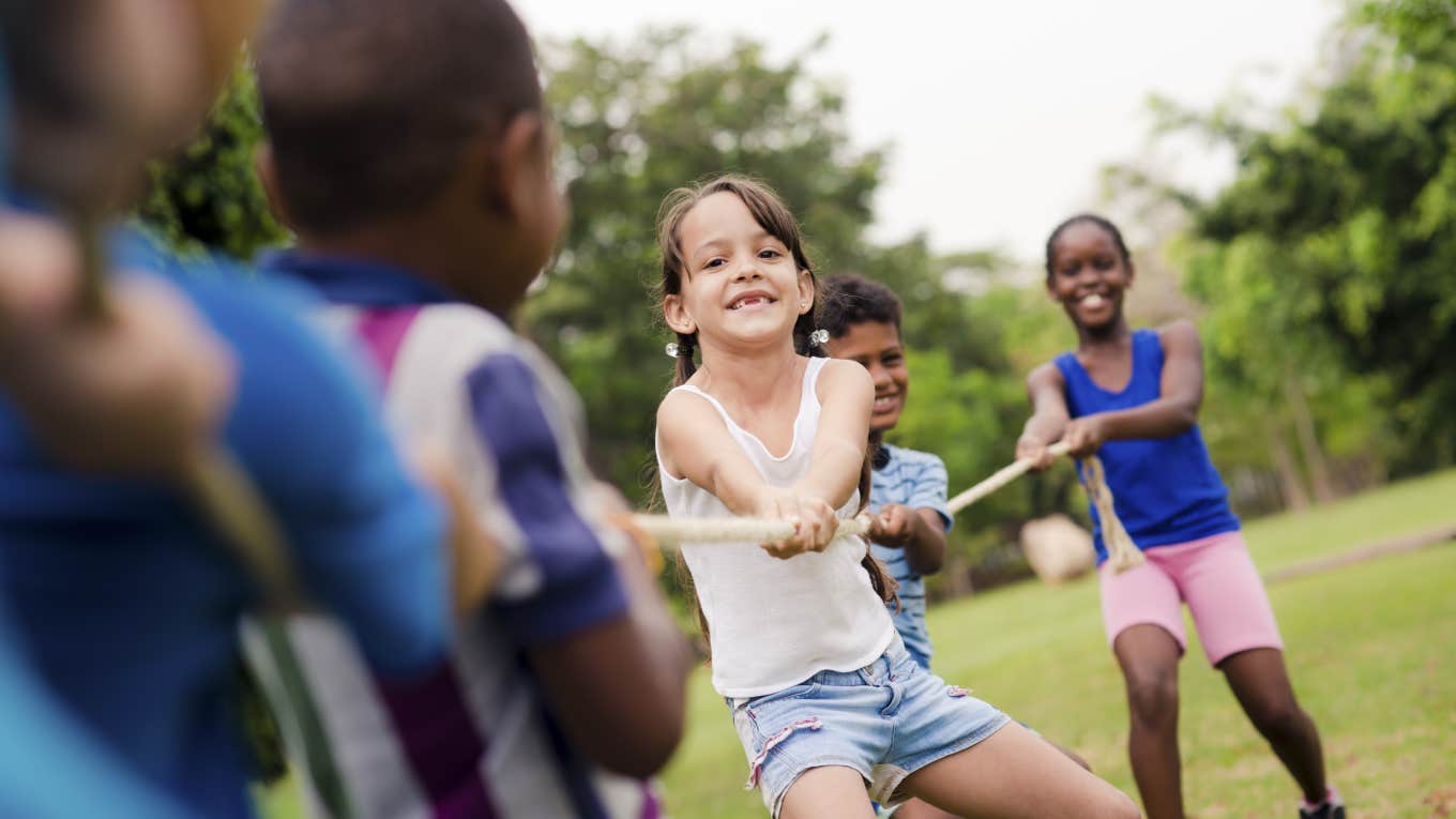 children playing tug of rope while at camp