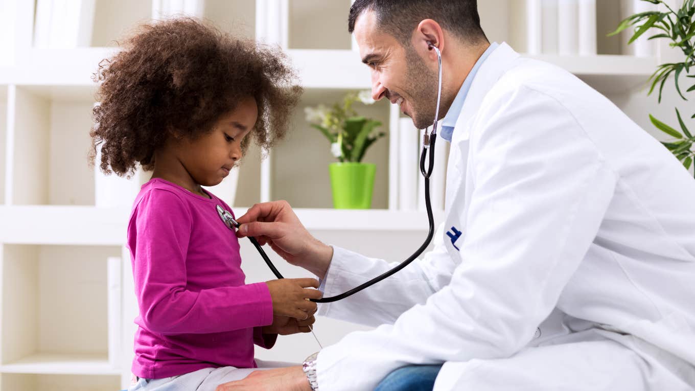 little girl at the doctor having her heartbeat listened to