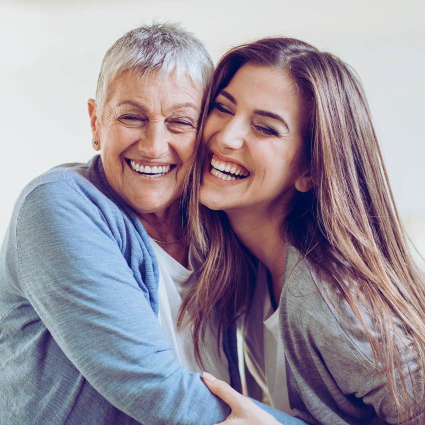 adult daughter and mother smiling and hugging