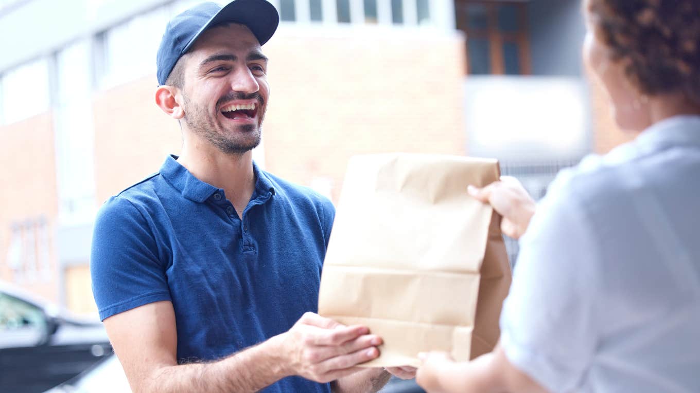 Delivery driver handing food to a customer. 