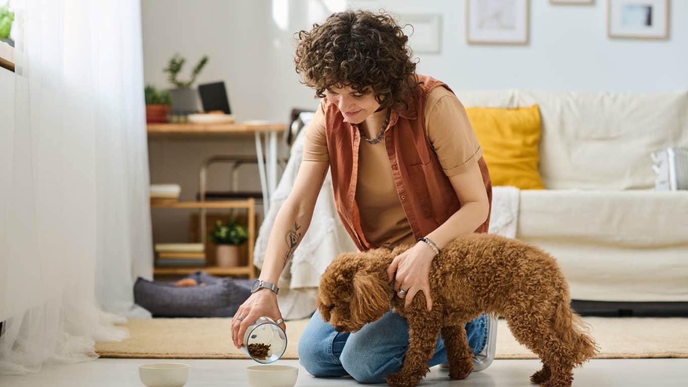 Owner feeding her pet at home